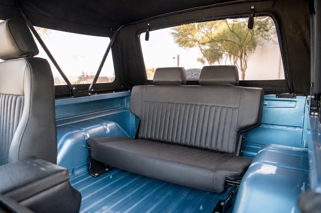 Rear interior with black upholstery in the restored Bronco